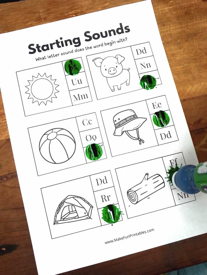 Preschool worksheet focused on identifying beginning letter sounds using pictures and letter choices